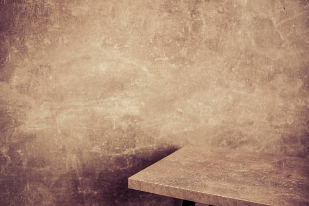 istock wooden desk table or shelf near concrete painted wall background texture surface, front view of tabletop 1294259683