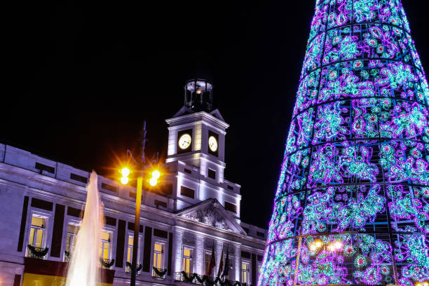 Christmas in the city of Madrid at night. The christmas tree in Sol Square with the clock of the Post House (spanish: casa de correos) illuminated at night, Madrid, Spain. 2655 stock pictures, royalty-free photos & images