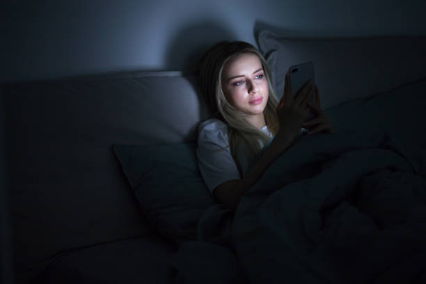 istock Social network addiction, Woman using smart phone at late night. 1294260137