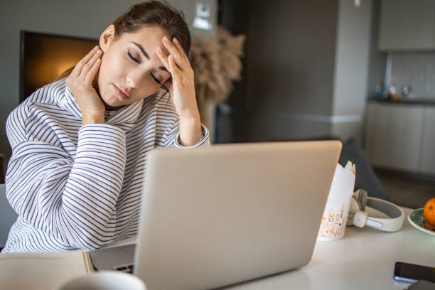 istock Young woman working from home and feeling stressed 1294260323
