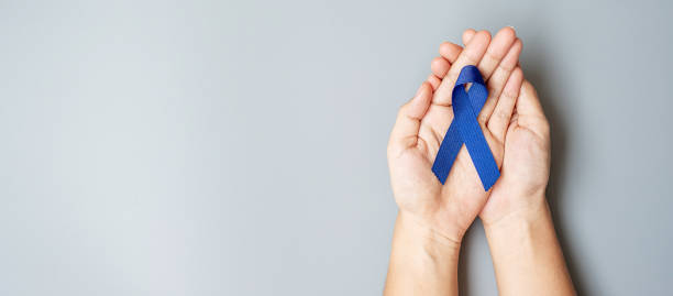 March Colorectal Cancer Awareness month, Man holding dark Blue Ribbon for supporting people living and illness. Healthcare, hope and World cancer day concept March Colorectal Cancer Awareness month, Man holding dark Blue Ribbon for supporting people living and illness. Healthcare, hope and World cancer day concept colon photos stock pictures, royalty-free photos & images