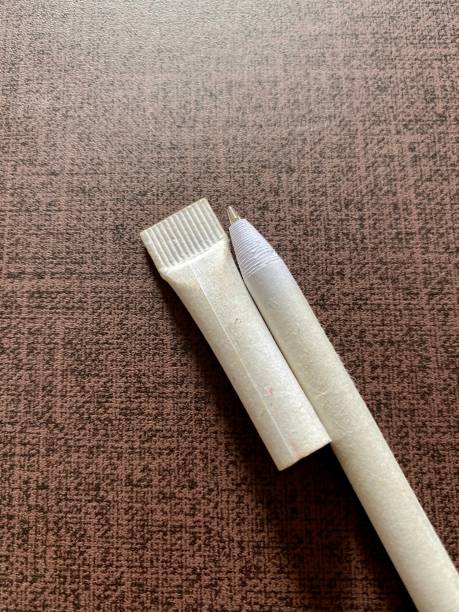 istock White ballpoint oen and cap kying on briwn surface 1294265026