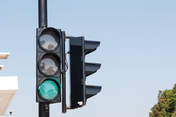 istock Green traffic light ,isolated on sky background 1294266454