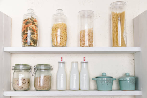 istock Various uncooked groceries in glass jars on shelf in kitchen 1294267354