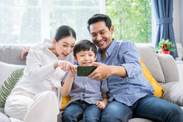 istock Asian family happy with internet technology on smartphone together 1294268686