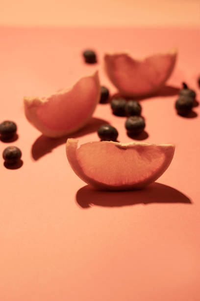 Grapefruit and blueberry background in pink