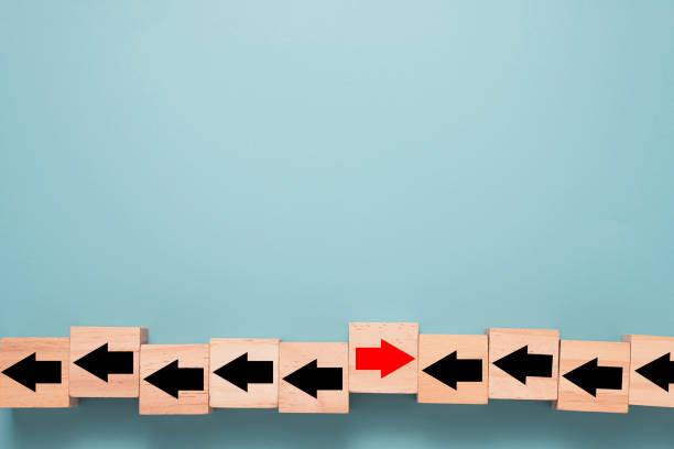 istock Business disruption and different thinking idea concept ,Wooden cube block which print screen red arrow is change left to right direction on blue background and copy space. 1294272591
