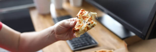 Male arms taking big piece of crusty fresh pizza