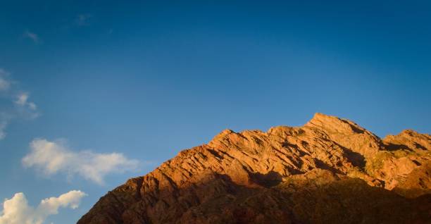 istock Rocky outcrop at sunset against clear blue sky. 1294277323