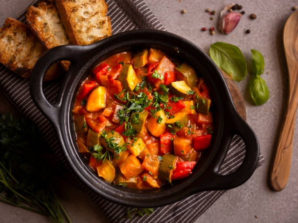 istock Cooked various chopped vegetables with herbs in a black cooking pot 1294278615