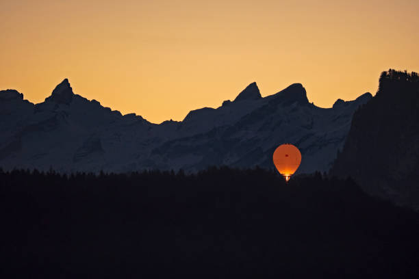Hot air balloon over the mountains at sunrise