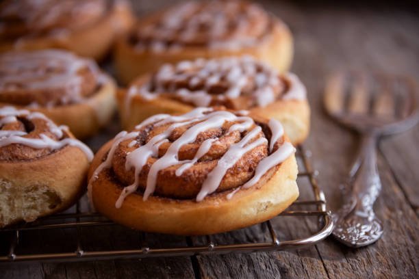 istock Fresh home baked sweet cinnamon buns with frosting 1294283544