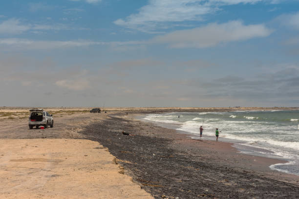 Surf fishing on the Skeleton Coast in the north of Swakopmund, Namibia skeleton coast, namibia-december 27, 2020: Surf fishing on the Skeleton Coast in the north of Swakopmund, Namibia swakopmund photos stock pictures, royalty-free photos & images