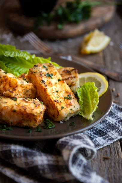 istock Cooked fish fillet with lemon and vegetables 1294284777