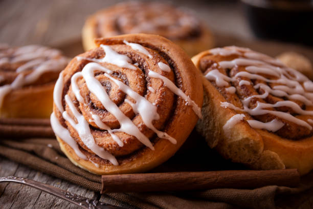 istock Fresh home baked sweet cinnamon buns with frosting 1294287144