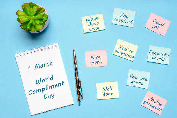 happy world compliment day. office desk with plant, notebook, pen and paper slips with compliments text for office worker such as good job. greeting card for world compliment day. flat lay, top view - cheerful cactus imagens e fotografias de stock