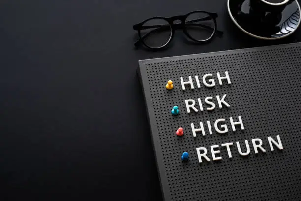 Photo of High risk high return text on desk.business motivation and growth