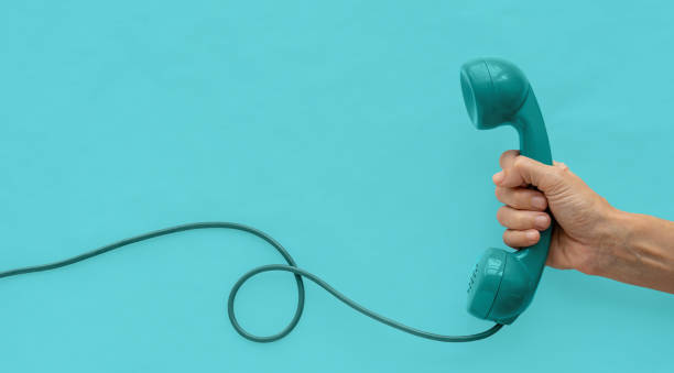 istock A vintage dial telephone handset with one hand and background. 1294288541