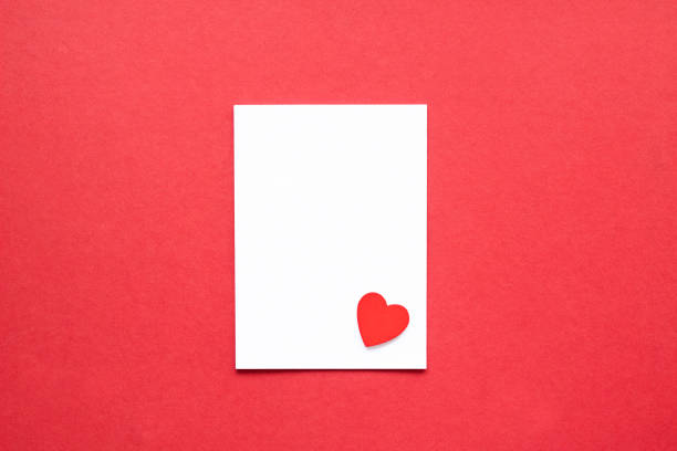istock blank white paper with heart on red background 1294290833