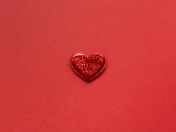istock one shiny red heart on red background . love background 1294290900