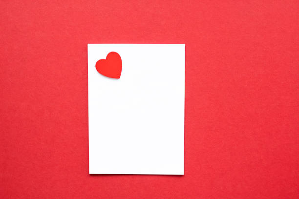 istock blank white paper with heart on red background 1294290960