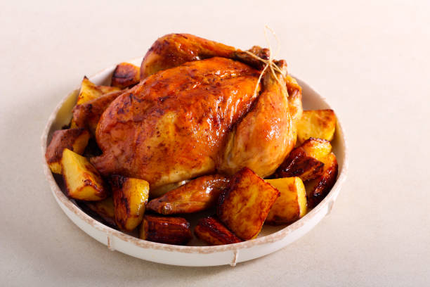 istock Roast chicken with potatoes on plate 1294292093