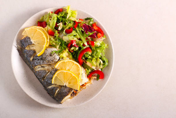 istock Sea bass fish with salad 1294292456