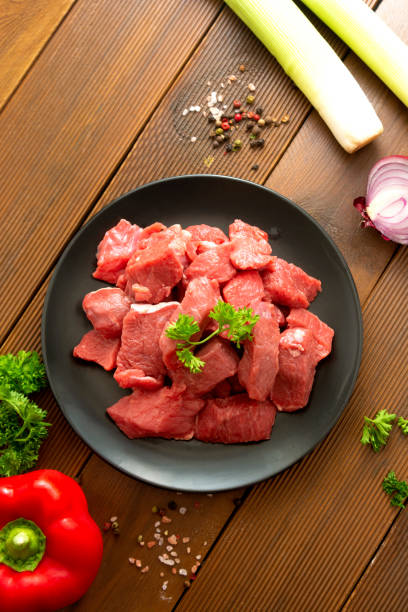 istock Beef uncooked raw steak on black plate, wooden board. 1294292476