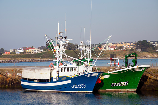 Foz, Spain- May 28, 2020: Two fishing boats mooring, Foz, A Mariña touristic area, Lugo province,  fishing harbor, Galicia, Spain.
