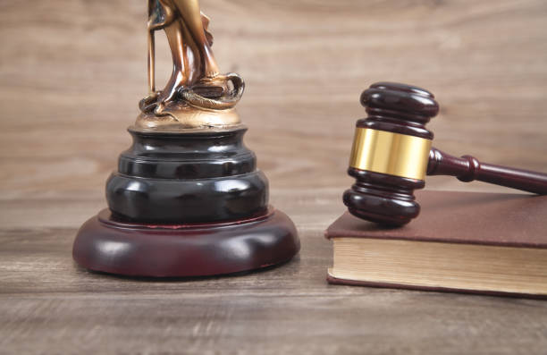 istock Statue of Lady Justice, book and gavel. 1294295224