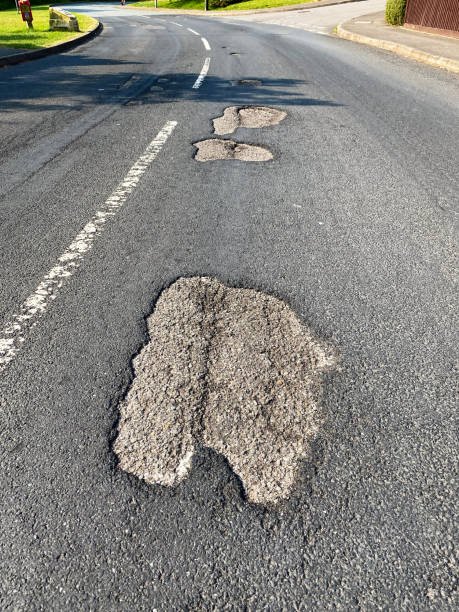 istock Potholes on the surface of a road 1294297383