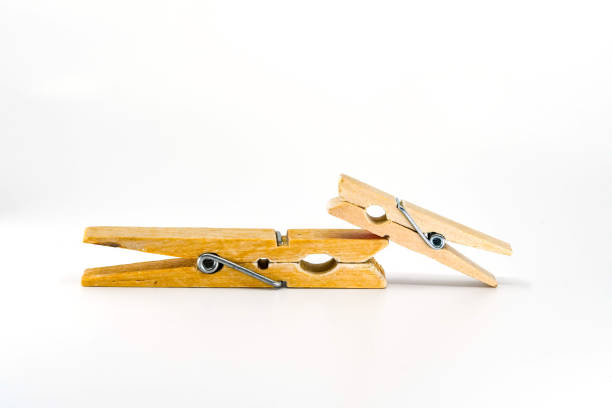 istock Small and large clothes pegs isolated on a white background 1294297661