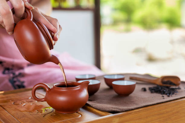 istock Woman serving Chinese tea in a tea ceremony 1294299767