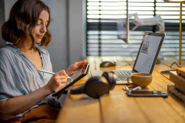 istock Creative woman with a digital tablet at home office 1294300215