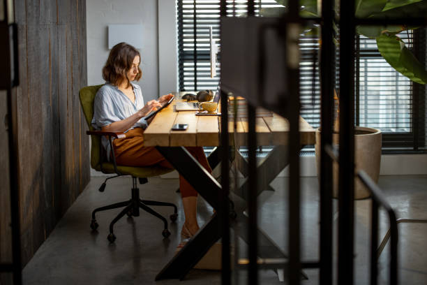istock Creative woman with a digital tablet at home office 1294300247