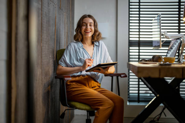 istock Creative woman with a digital tablet at home office 1294300251