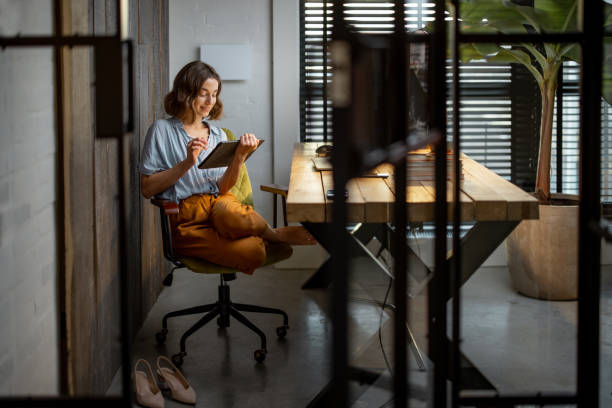 istock Creative woman with a digital tablet at home office 1294300783
