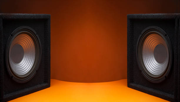 Black subwoofer speaker car audio music system on orange background Black subwoofer speaker car audio music system on orange background subwoofer photos stock pictures, royalty-free photos & images