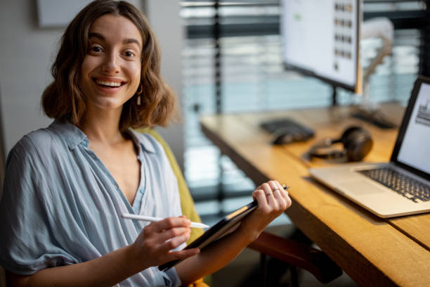 istock Creative woman with a digital tablet at home office 1294300794