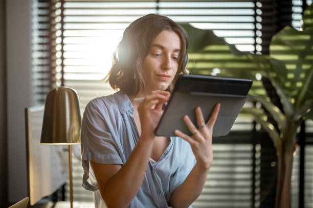 istock Woman working on a digital tablet at home office 1294300833
