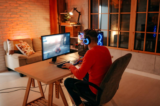 istock Mature  man playing online games on laptop computer at home. 1294302226