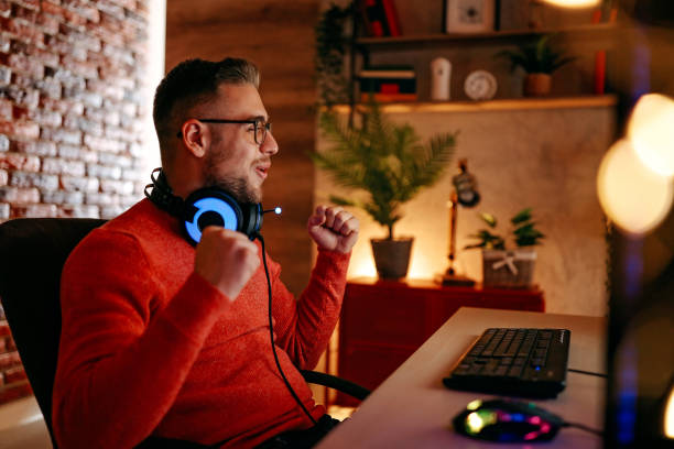 istock Mature  man playing online games on laptop computer at home. 1294302289