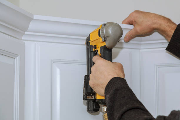 istock A worker using portable air gun nail in the nailing to crown moldings on kitchen 1294303385