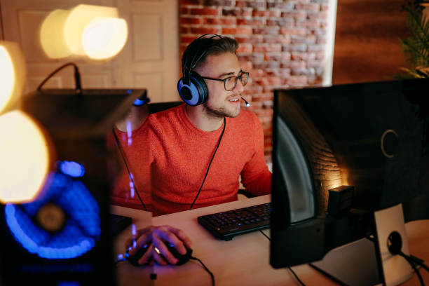 istock Mature  man playing online games on laptop computer at home. 1294304561