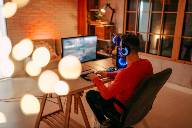 istock Mature  man playing online games on laptop computer at home. 1294304618