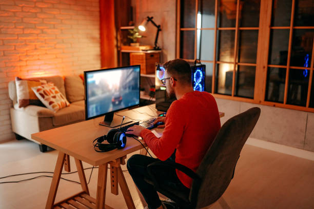 istock Mature  man playing online games on laptop computer at home. 1294304677