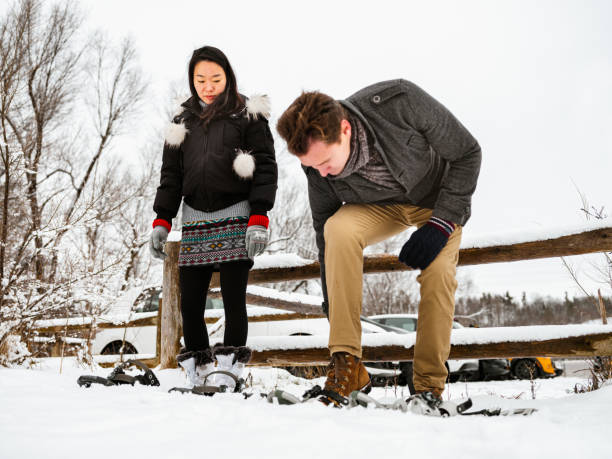 istock Mixed race couple snowshoeing in winter 1294304763
