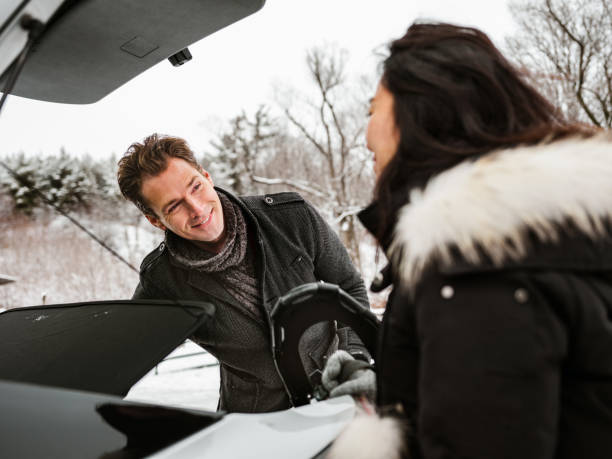 istock Mixed race couple unloading car in winter 1294304815