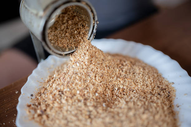 High angle view of a walnut grinder placed on a kitchen counter. Selective focus on the grinding machine