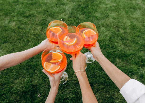glass cocktail orange four hands party outside